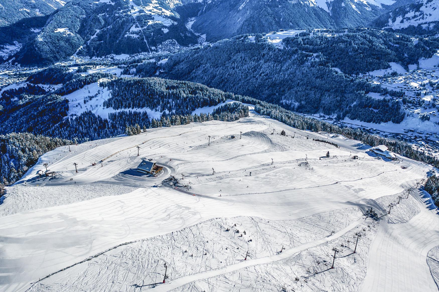 Wide open ski resort of Les Gets with snowy trees in background